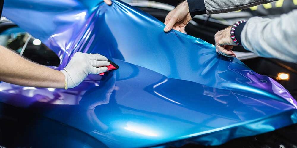 vehicle being wrapped with vinyl wrapping